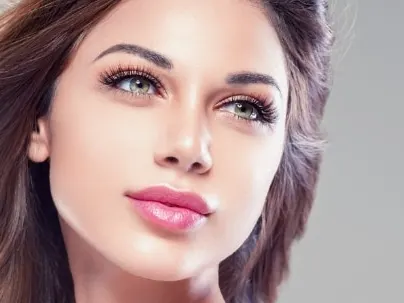 A model with long brown hair and full pink lips