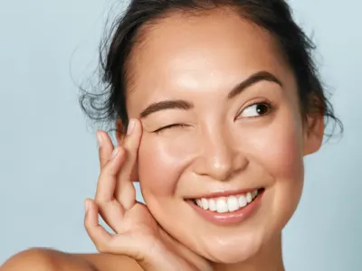 Beautiful woman with glowing skin after photorejuvenation treatment.