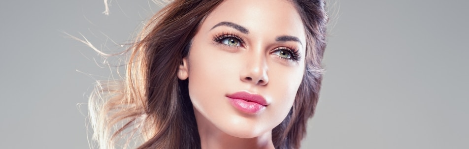 A model with long brown hair and full pink lips