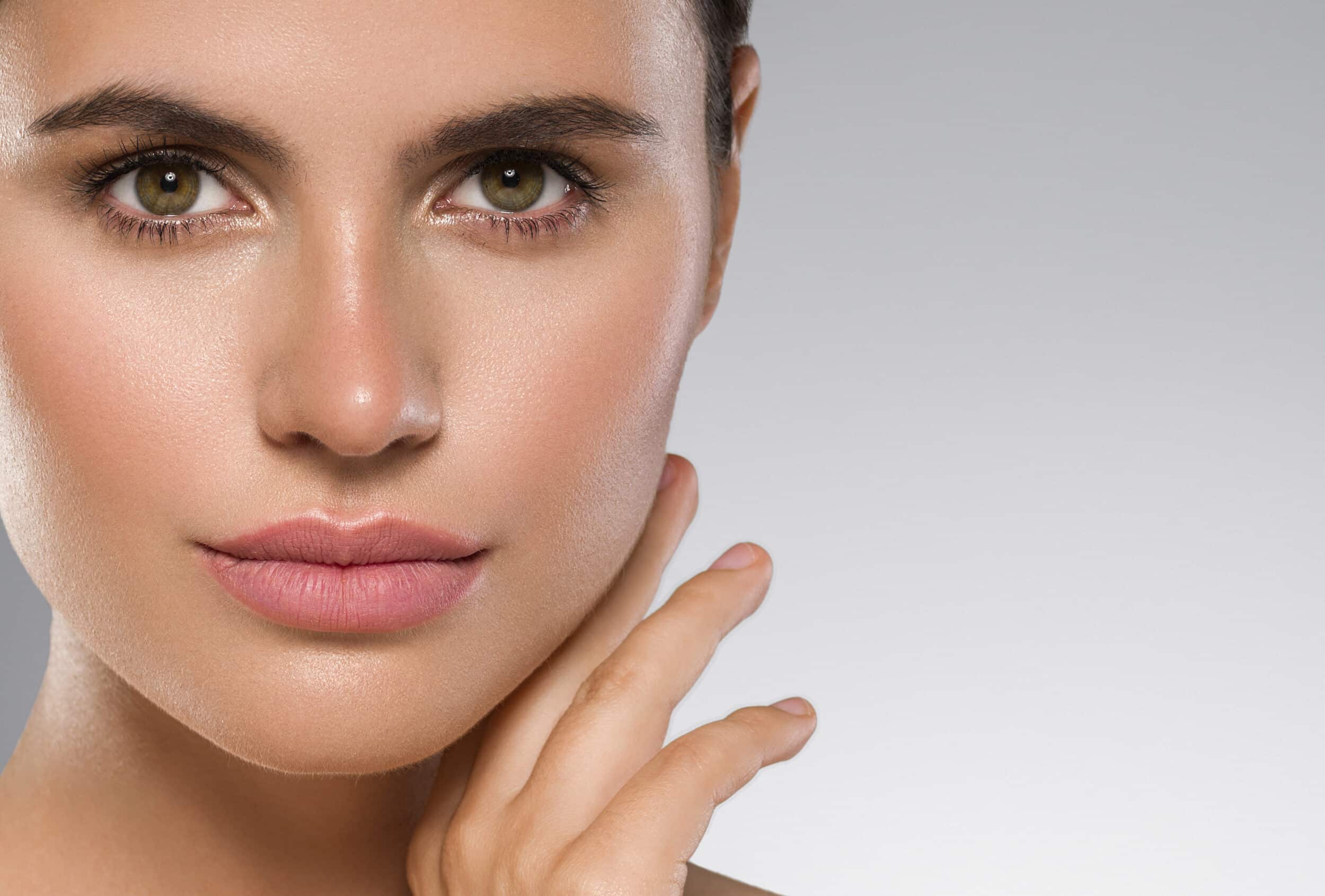A woman showing her healthy skin from retinol treatment.