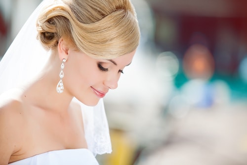 Bride with glowing skin on her wedding day after following the right skincare timeline.