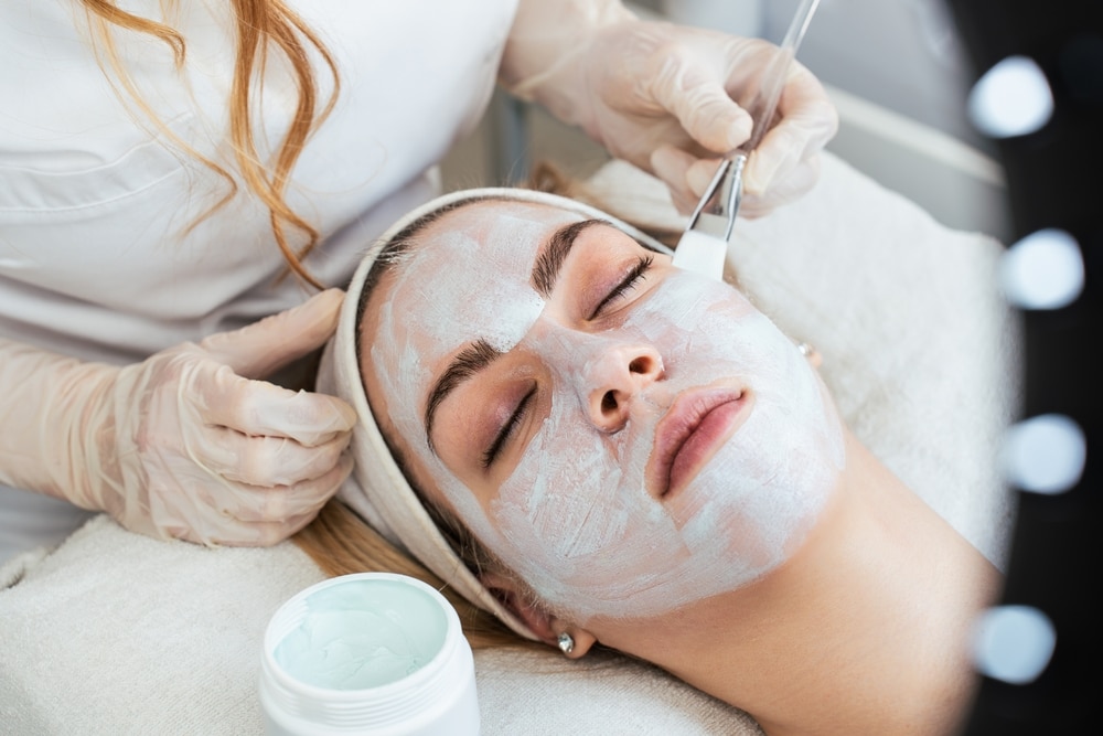Woman getting facial treatment to reset skin after the holidays