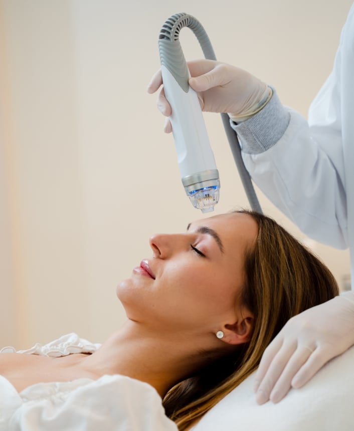 Woman receiving a chemical peel application to her face during a professional skin care treatment.